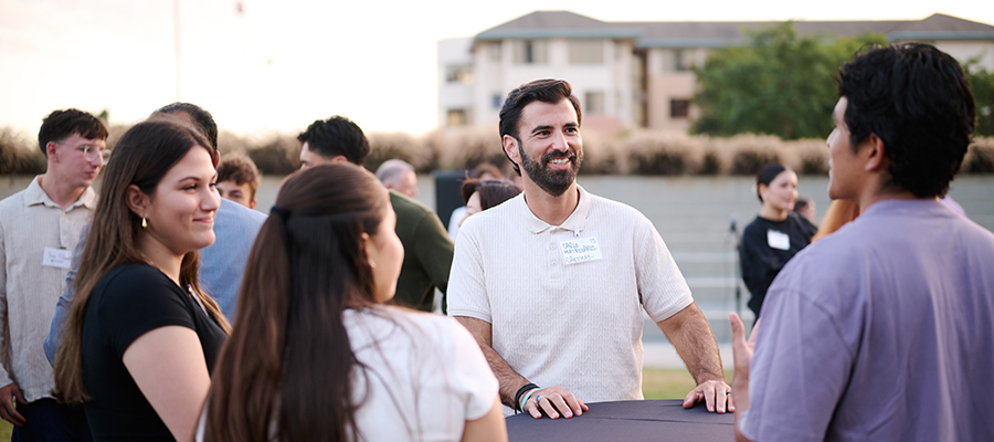 Real Estate Advisory Council member mingling with students
